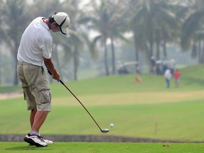A golfer plays a round at a course in Sanya, China