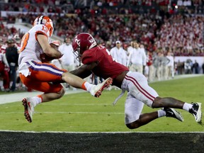 Clemson Tigers' Hunter Renfrow hauls in the game-winning touchdown against Alabama Crimson Tide defender Tony Brown with just seconds remaining in the Monday night NCAA football championship game at Tampa. Renfrow's touchdown made the final score 35-31 and avenged last year's loss to the Tide. The victory marked Clemson's first national title since 1981.