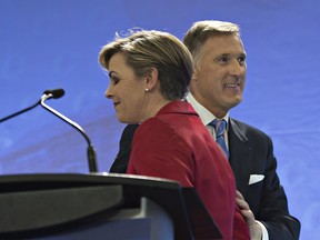 Leadership candidates Kellie Leitch, left, and Maxime Bernier greet each other at the beginning of the Conservative Party French language leadership debate, Tuesday, January 17, 2017 in Quebec City.