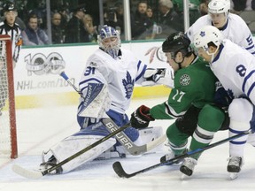 Devin Shore of the Dallas Stars fights off the check of Toronto Maple Leafs' defenceman Connor Carrick to score past Leafs' goaltender Frederik Andersen during NHL action Tuesday night in Dallas. The Stars were 6-3 winners.
