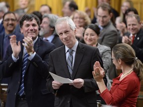 Former foreign affairs minister Stephane Dion is applauded by fellow MPs before making his final statement in the House of Commons in Ottawa, Tuesday, Jan.31, 2017.