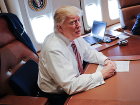 President Donald Trump at his desk on Air Force One on Thursday.