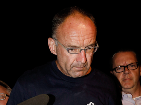 Accused murderer Douglas Garland is escorted into a Calgary police station in 2014.