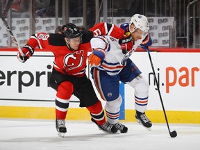 New Jersey Devils forward Taylor Hall (left) battles Edmonton Oilers defenceman Adam Larsson for the puck on Jan. 7.