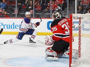 Edmonton Oilers winger Jordan Eberle (left) shoots on New Jersey Devils goaltender Cory Schneider on Jan. 7.