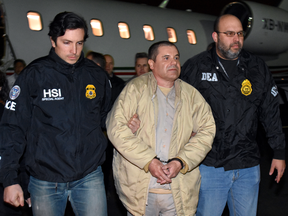 American authorities escort Joaquin "El Chapo" Guzman from a plane at Long Island MacArthur Airport on Thursday, Jan. 19, 2017, in Ronkonkoma, N.Y.