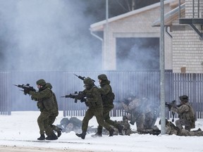 In this Friday, Dec. 2, 2016 file photo, soldiers take part in the NATO military exercise 'Iron Sword 2016' at a training range in Pabrade, north of the capital Vilnius, Lithuania, as part of an exercise in response to Russian aggression. Now, the Baltic state is looking to build a fence along its border with Russia.