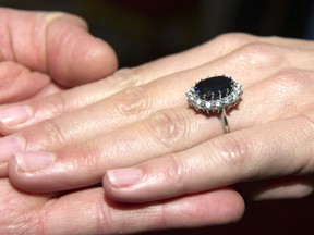 The massive sapphire-and-diamond engagement ring that once belonged to Princess Diana now sits on the Duchess of Cambridge's left hand, seen here in a photo released shortly after her betrothal to Prince William.