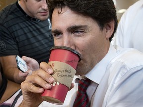 Justin Trudeau sips on a coffee while chatting with patrons during a campaign stop at Tim Hortons in Gatineau in September, 2015.