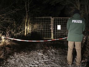 A police officer stands in front of a closed off entrance to a private ground near Arnstein, Germany, Sunday Jan. 29, 2017