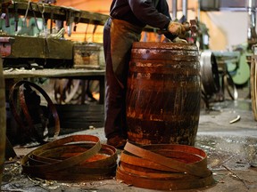 A cooper works on a cask at the Speyside Cooperage.