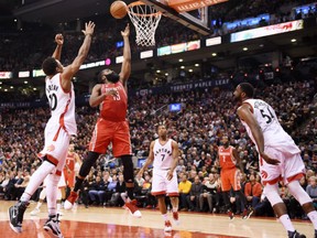 James Harden of the Houston Rockets goes up for two of his game-high 40 points in NBA action Sunday against the Toronto Raptors at the ACC. Defending on the play is Raptors' guard DeMar DeRozen, left. The Rockets spotted the Raptors a four-point lead heading into the fourth quarter before lifting off to a 129-122 victory.
