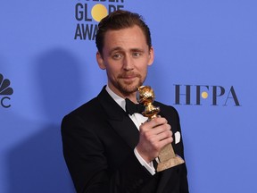 Hiddleston clutching that Golden Globe for dear life.