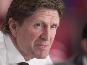 In this Oct. 6 file photo, Toronto Maple Leafs coach Mike Babcock watches his team warm up before a pre-season game against the Montreal Canadiens.