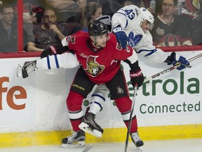 Ottawa Senators defenceman Chris Wideman (left) checks Toronto Maple Leafs centre Nazem Kadri along the boards on Jan. 14.
