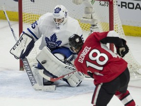 Ottawa Senators forward Ryan Dzingel (right) shoots on Toronto Maple Leafs goaltender Curtis McElhinney on Jan. 14.