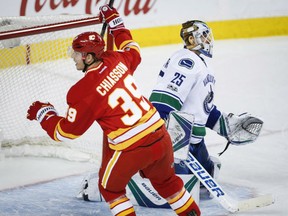 Vancouver Canucks goalie Jacob Markstrom looks away as the Flames' Alex Chiasson celebrates his goal during third period of their game in Calgary on Saturda night.