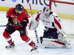 Jean-Gabriel Pageau of the Senators looks on as the puck is deflected off Washington Capitals goalie Braden Holtby during the second period in Ottawa on Saturday night.