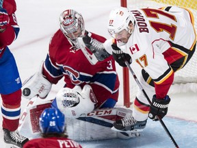 Montreal Canadiens goalie Carey Price upends Calgary Flames' Lance Bouma as he slides into the crease in Montreal on Tuesday.