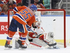 Calgary Flames goalie Brian Elliott is scored on by the Oilers' Mark Letestu in a shootout during their game in Edmonton on Saturday night.