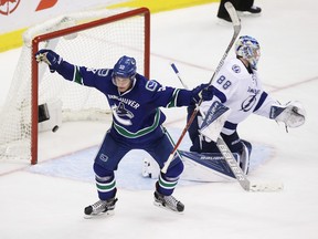 Vancouver Canucks forward Bo Horvat (left) celebrates scoring on Tampa Bay Lightning goaltender Andrei Vasilevskiy on Dec. 16.