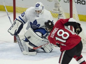 Toronto Maple Leafs goalie Curtis McElhinney (left) makes a save on a shot by Ottawa Senators forward Ryan Dzingel on Jan. 14.