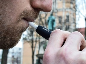 Philip Morris International is promoting new products designed to give customers a hit of nicotine while leaving out the disease-triggering chemicals, including the iQOS, which heats up tobacco but doesn’t burn it and produce toxic smoke.
