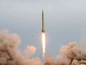 In a handout picture released on the news website of Iran's Revolutionary Guards, an Iranian Shahab-3 missile