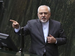 FILE - In this file photo dated Sunday, Oct. 2, 2016, Iranian Foreign Minister Mohammad Javad Zarif answers questions from lawmakers in an open session of parliament in Tehran, Iran, explaining the nuclear deal with world powers.  Iran is to receive a huge shipment of natural uranium from Russia to compensate it for exporting tons of reactor coolant, according to unidentified Iranian diplomats Monday Jan. 9, 2017, in a move approved to keep Tehran committed to a landmark nuclear pact.  (AP Photo/Vahid Salemi, FILE)