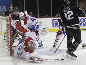 Montreal Canadiens' goaltender Carey Price denies the scoring attempt of New York Islanders' Josh Bailey from close in during NHL action Thursday night in Brooklyn, N.Y. Despite 39 saves by Price, the Canadiens were on the losing end of a 3-1 score.