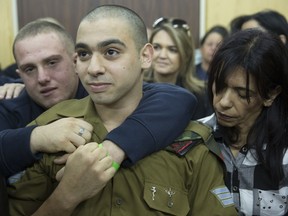 Israeli solider Sgt. Elor Azaria waits with his parents for the verdict inside the military court in Tel Aviv, Israel on Wednesday, Jan. 4, 2017