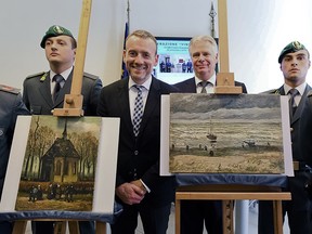 In this Friday, Sept. 30, 2016 file photo, Director of Amsterdam's Van Gogh Museum Axel Rueger, center, stands next to the paintings 'Congregation Leaving The Reformed Church of Nuenen', left, and 1882 'Seascape at Scheveningen' by Vincent Van Gogh, during a press conference in Naples, Italy.