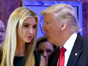 US President-elect Donald Trump whispers to his daughter Ivanka during a press conference Jan. 11, 2017 at Trump Tower in New York.