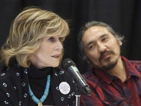 Jane Fonda speaks as Athabasca Chipewyan First Nation Chief Allan Adam looks on during a press conference for indigenous rights in Edmonton Alta, on Wednesday, January 11, 2017.