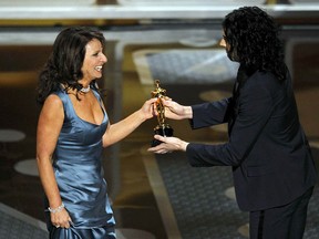 Director Susanne Bier (L) accepts the Oscar for best foreign film for the Danish film "In A Better World" during the 83rd Academy Awards in Hollywood, California, February 27, 2011.