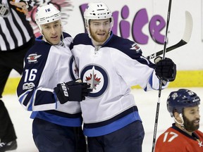 Shawn Matthias,left,  is congratulated by Winnipeg Jets teammate Adam Lowry after scoring against the Florida Panthers during the second period of their game Wednesday night in Sunrise, Fla.