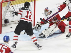 Julien Gauthier of Team Canada sweeps the puck into a basically unguarded Czech Republic net during quarter-final action at the world junior hockey championship in Montreal on Monday.  Czech goaltender Jakub Skarek finds himself out of position. Canada posted a 5-3 win to advance against Sweden in semifinal action on Wednesday in Montreal.