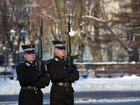 Soldiers lift their rifles during an honor guard beside the Freedom monument in Riga, Latvia, on Tuesday, Jan. 10, 2017