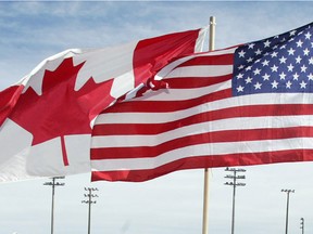 The Canadian and U.S. flags fly side by side.