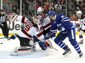 Zach Hyman watches a shot by Toronto Maple Leafs teammate Auston Matthews enter the net behind Devils goaltender Cory Schneider for a goal during the first period of their game Friday night in Newark, N.J.