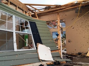 A house is caved in along Collins Road in Petal, Mississippi, following a predawn tornado on Saturday, Jan., 21.  The same system also destroyed a mobile home park in Georgia, killing several people.