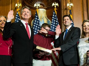 House Speaker Paul Ryan of Wis. administers the House oath of office to Rep. Roger Marshall, R-Kan., during a mock swearing in ceremony on Capitol Hill in Washington, Tuesday, Jan. 3, 2017,  as his son dabs, a pose made popular by NFL quarterback Cam Newton.