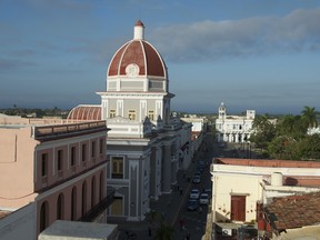 Skyline of the port city of Cienfuegos from the rooftop bar of La Union Hotel. Years of conflict and neglect are evident in the harsh morning light.