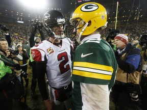In this Dec. 8, 2014, file photo, Atlanta Falcons quarterback Matt Ryan talks to Green Bay Packers quarterback Aaron Rodgers after an NFL game in Green Bay, Wis. The Packers and Falcons play in the NFC Championship on Sunday, Jan. 22, 2017, in Atlanta.