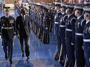 President Barack Obama is escorted by Army Col. Jason T. Garkey, left, as they review the troops during an Armed Forces Full Honor Farewell Review for the president, Wednesday, Jan. 4, 2017, at Conmy Hall, Joint Base Myer-Henderson Hall, Va.