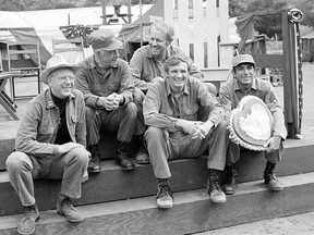 Cast members of the television series M*A*S*H from left: William Christopher, Harry Morgan, Mike Farrell, Alan Alda, and Jamie Farr, take a break on the set during taping in Los Angeles Sept. 15, 1982. Christopher died Saturday, Dec. 31, 2016. He was 84.