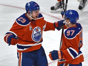 Edmonton Oilers forwards Leon Draisaitl (left) and Connor McDavid celebrate a goal against the Tampa Bay Lightning on Dec. 17.