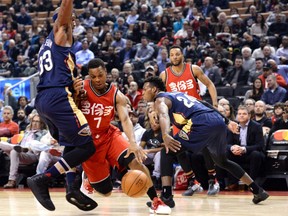 Kyle Lowry of the Toronto Raptors drives hard to the lane against New Orleans Pelicans defenders Dante Cunningham, left, and Buddy Hield during NBA action Tuesday night at the Air Canada Centre. Lowry was a ball hawk for the Raptors with 33 points including the game-winner in overtime as the Raptors prevailed, 108-106.