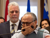 Mohamed Labidi, vice-president of the Islamic cultural centre, is comforted by Quebec Premier Philippe Couillard during a news conference about the deadly shooting at a mosque in Quebec City on Monday, Jan. 30, 2017.