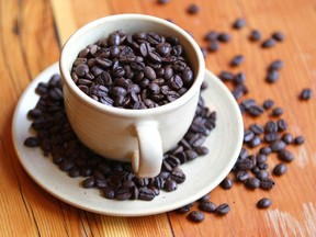 A coffee cup filled with coffee beans